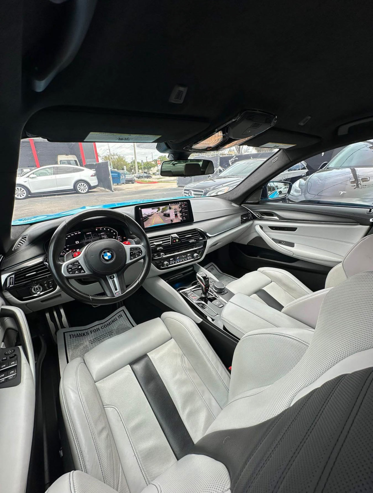 BMW interior (white seats) after detailing