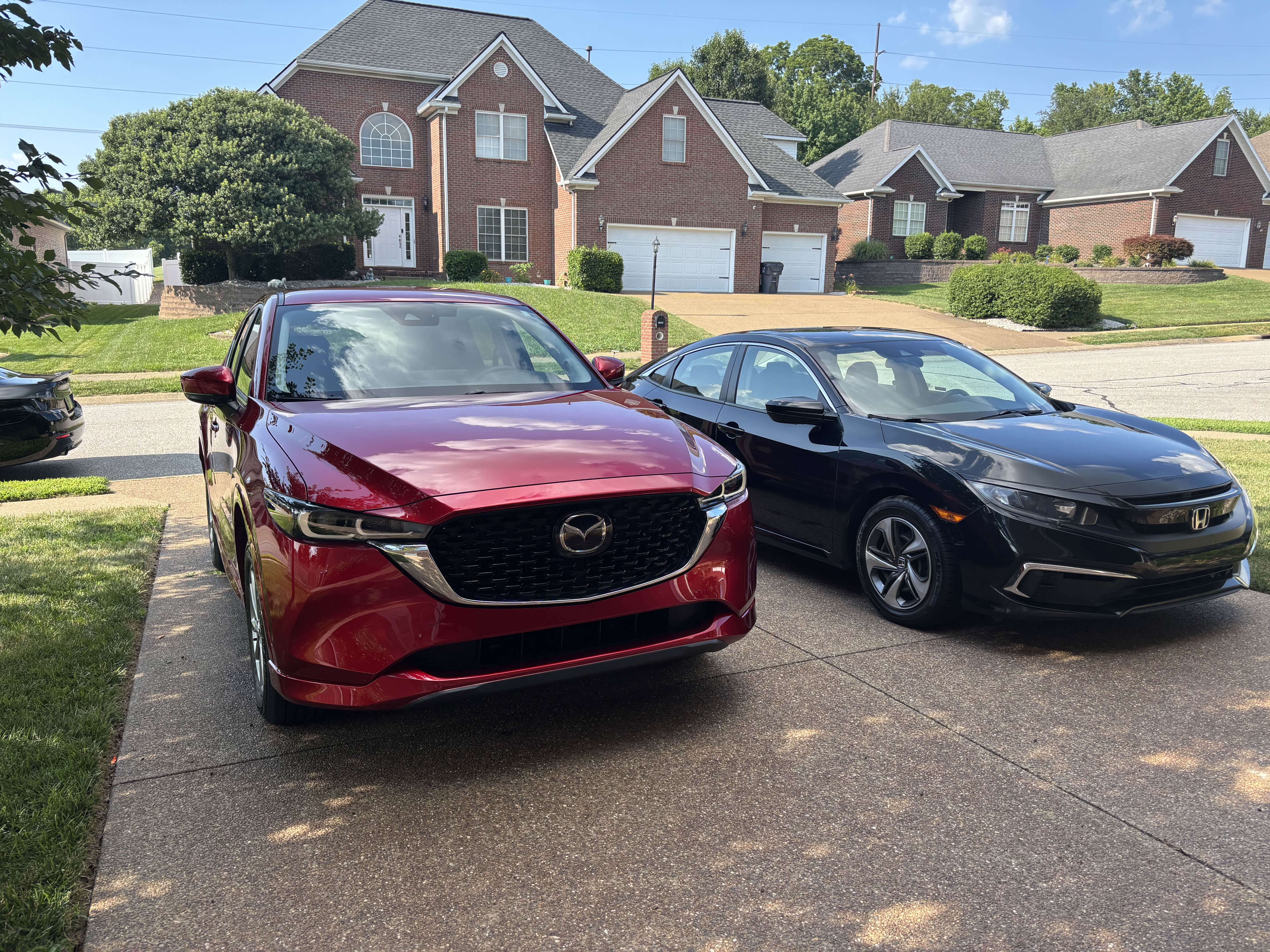 Red Mazda CX-5 and black Honda Civic after detailing